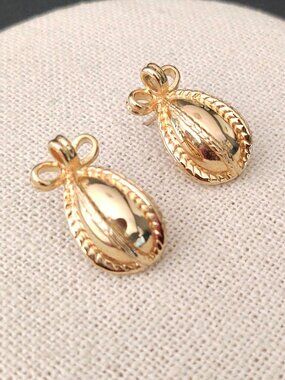 Gold egg shaped with top bow detail earrings